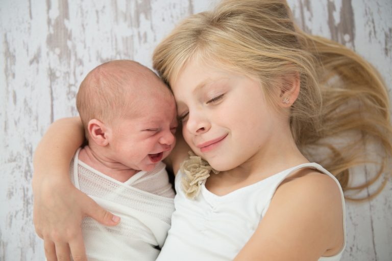 Newborn baby and sibling
